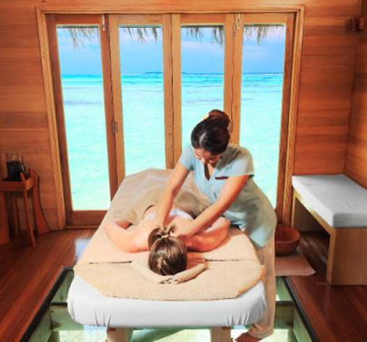 image of woman lying on massage board receiving massage from a female masseur